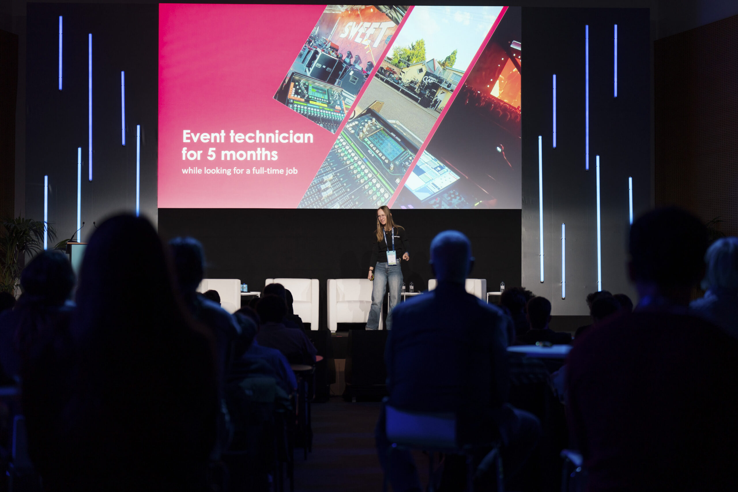 Jasmin Thieme präsentiert auf der Bühne des AV Career Day bei der ISE 2026 eine Folie zu ihrer Tätigkeit als Eventtechnikerin vor ihrer Position bei PROTONES.